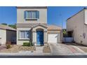 Two-story house with blue door and attached garage at 10082 Swimming Hole St, Las Vegas, NV 89183