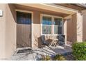 Small front porch with two chairs and a table at 10444 Britton Hill Ave, Las Vegas, NV 89129