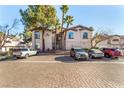 Two-story building with ample parking and palm trees at 108 Breezy Tree Ct # 202, Las Vegas, NV 89145