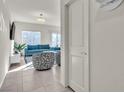 Bright living room with teal sofas and a modern coffee table at 10931 Cambridge Lakes Ave, Las Vegas, NV 89166