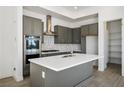 Modern kitchen with stainless steel appliances and gray cabinetry at 11809 Stone Run Ave, Las Vegas, NV 89138