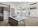 Open concept kitchen and living area with modern finishes and large windows at 11809 Stone Run Ave, Las Vegas, NV 89138