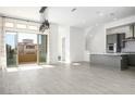 Bright living room with sliding glass doors leading to a balcony at 11809 Stone Run Ave, Las Vegas, NV 89138