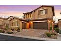 Two-story house with brown exterior, landscaped yard, and a three-car garage at 12031 Attiva Ave, Las Vegas, NV 89138