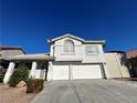 Two-story house with a two-car garage and landscaped yard at 1526 Carriagedale Ct, Las Vegas, NV 89110