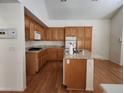 Kitchen with oak cabinets, granite countertops, and hardwood floors at 1526 Carriagedale Ct, Las Vegas, NV 89110