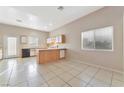 Kitchen with light wood cabinets, tile floors, and island at 1619 Wendell Williams Ave, Las Vegas, NV 89106