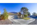 House exterior with a driveway and mature trees at 2044 Glorieta Ln, Las Vegas, NV 89134