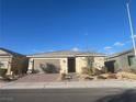 House exterior showcasing a two-car garage and well-maintained landscaping at 2110 Millergrove Ave, North Las Vegas, NV 89086