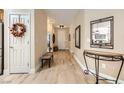 Light hardwood floors and decorative mirror in entryway at 2401 Weaverville Dr, Henderson, NV 89044