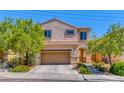 Tan two-story house with a tan garage and landscaping at 2744 Drummossie, Las Vegas, NV 89044