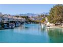 Community waterfront view of canal homes and boats, set against a scenic mountain backdrop at 3173 Lido Isle Ct, Las Vegas, NV 89117