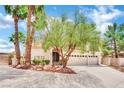 Two-story house with three-car garage and desert landscaping at 3380 Shallow Pond Dr, Las Vegas, NV 89117