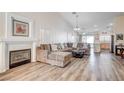 Spacious living room with L-shaped sectional sofa and fireplace at 3790 Morning Canyon St, Las Vegas, NV 89147