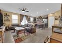 Spacious living room with leather couches, a coffee table, and a kitchen view at 4823 Kinworthy St, North Las Vegas, NV 89081