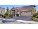 Single-story home with a neutral color palette and a welcoming porch at 5977 Ancient Peaks Ave, Las Vegas, NV 89141