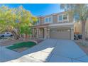 Two-story house with a gray exterior, two-car garage, and landscaped front yard at 6607 Musette Ave, Las Vegas, NV 89139