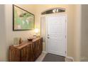 Bright entryway with wood console table and large world map art at 750 Arguello Cir, Mesquite, NV 89027