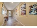 Long hallway with tiled floors and wall art at 844 Via Serenelia, Henderson, NV 89011