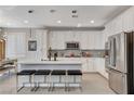 Bright kitchen featuring white cabinets and a center island at 889 Ariel Heights Ave, Las Vegas, NV 89138