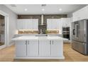 Modern kitchen with white cabinets, large island, and stainless steel appliances at 9008 Rolling Pietra St, Las Vegas, NV 89166