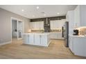 Modern kitchen with white cabinets, large island, and stainless steel appliances at 9008 Rolling Pietra St, Las Vegas, NV 89166