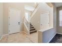 Two-story entryway with staircase and tile flooring at 9494 Stillwater Bend Ln, Las Vegas, NV 89178