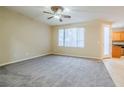 Spacious living room with neutral carpeting and ceiling fan at 9494 Stillwater Bend Ln, Las Vegas, NV 89178