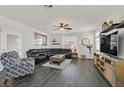 Spacious living room with dark hardwood floors and sectional sofa at 10330 Glacier Mist Ave, Las Vegas, NV 89149