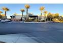 Modern community building with palm trees and parking lot at 11251 Hidden Peak Ave # 212, Las Vegas, NV 89135