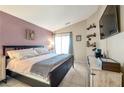 Spacious primary bedroom with a king-size bed and en-suite bathroom at 1861 Ridgefield Dr, Las Vegas, NV 89108