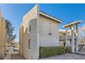 Side exterior view of a multi-story apartment building with stucco facade, a red tile roof, and landscaping at 1963 Scimitar Dr # 0, Henderson, NV 89014