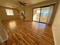 Spacious living room with hardwood floors and access to a balcony at 1963 Scimitar Dr # 0, Henderson, NV 89014