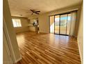 Spacious living room with hardwood floors and access to a balcony at 1963 Scimitar Dr # 0, Henderson, NV 89014