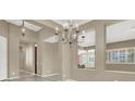 Elegant dining room with a chandelier and neutral color palette at 2423 Blair Castle St, Henderson, NV 89044