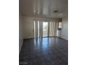 Living room with tile floors and sliding glass door at 2567 Paradise Village Way, Las Vegas, NV 89120