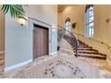 Grand lobby with mosaic tile floor, staircase, and elevator at 30 Via Mantova # 108, Henderson, NV 89011