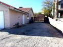 Side view of house showing gated access and a gravel area at 3139 Ocotillo Dr, Laughlin, NV 89029