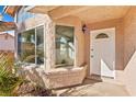 Front entryway with a white door and bay window at 3139 Ocotillo Dr, Laughlin, NV 89029