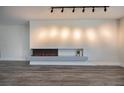 Modern linear fireplace with gray mantel and wood-look flooring at 3180 S Tioga Way, Las Vegas, NV 89117