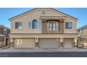 Three-car garage townhome with a small balcony and a neutral stucco finish at 3309 Jamaica Princess Pl # 3, North Las Vegas, NV 89084