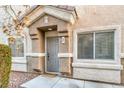 Gray front door with sidelights and landscaping at 3309 Jamaica Princess Pl # 3, North Las Vegas, NV 89084