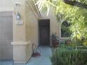 Front entry with walkway, mature trees, and potted plants at 3925 Vulcan St, Las Vegas, NV 89122