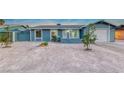 Newly renovated single-story home with a clean, light blue exterior and a spacious yard at 402 Bell Ave, Henderson, NV 89015