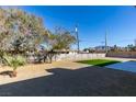 Landscaped backyard with artificial turf and a patio area at 4962 E Baltimore Ave, Las Vegas, NV 89104