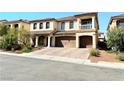 Two-story house with a brick driveway and desert landscaping at 6454 Mount Palomar Ave, Las Vegas, NV 89139