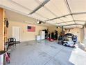 Spacious garage with epoxy flooring, storage, and home gym at 6454 Mount Palomar Ave, Las Vegas, NV 89139