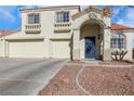 Two-story house featuring a blue front door and attached two-car garage at 718 Glenwood Springs Ave, North Las Vegas, NV 89032