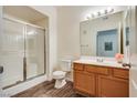 Bathroom with wood vanity, toilet, and shower stall at 833 Aspen Peak Loop # 2524, Henderson, NV 89011