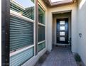 Front entry with black modern door, sidelights, and brick walkway at 8435 Great Outdoors St, Las Vegas, NV 89166